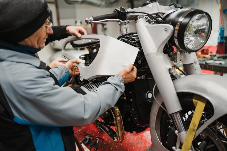 man-fixing-motorcycle-modern-workshop_158595-8081