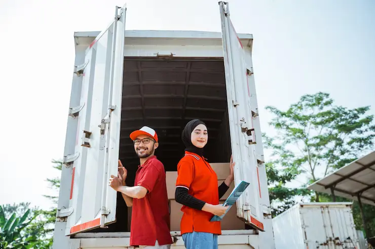 smiling-female-worker-holding-clipboard-with-delivery-man-closing-container-door-truck_8595-31864